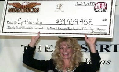 Cynthia Jay Brennan receiving a large cheque