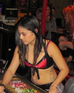 Casino croupier with tattoos