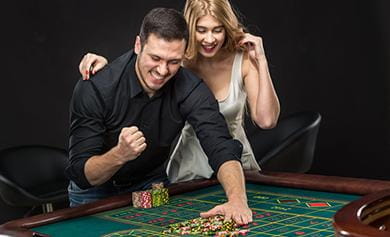 A pair of gamblers enjoying a roulette game