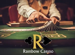 Image of a card game table with Rainbow Casino logo