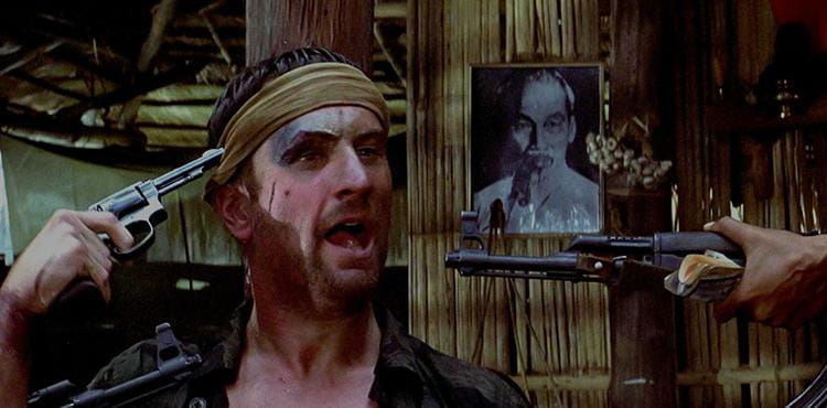 Image from the movie the Deer Hunter featuring Robert de Niro with a Gun