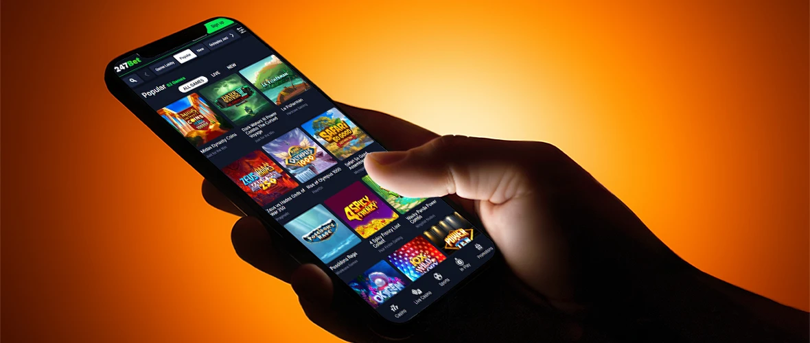 The 247Bet Casino lobby viewed on iPhone 15 — note the search bar placement and the provider filter.