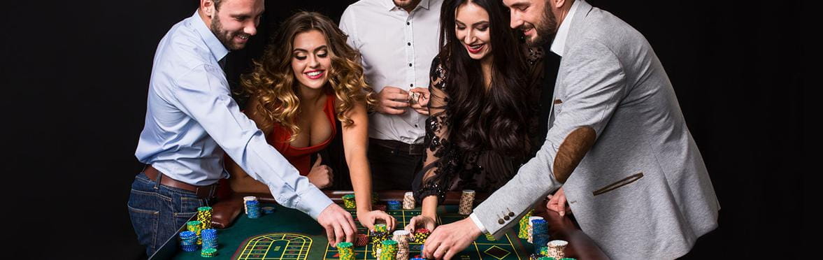 An image of glamorous casino guests at a roulette table