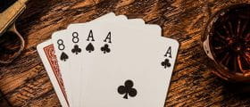 A Hand That Consists Of Two Pairs of Black Aces and Black Eights