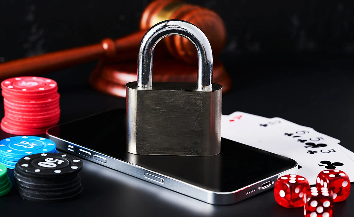 A Padlock, a Smartphone, and Casino Chips Representing Regulation in Online Gambling. 