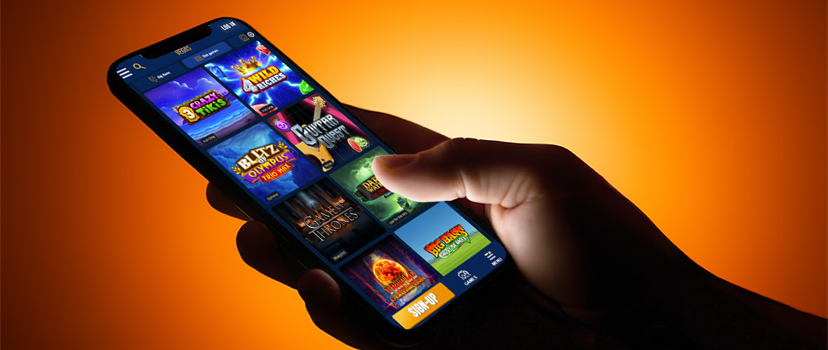 The Dream Vegas casino lobby viewed on iPhone 15 — note the search bar placement and the jackpot category tab.