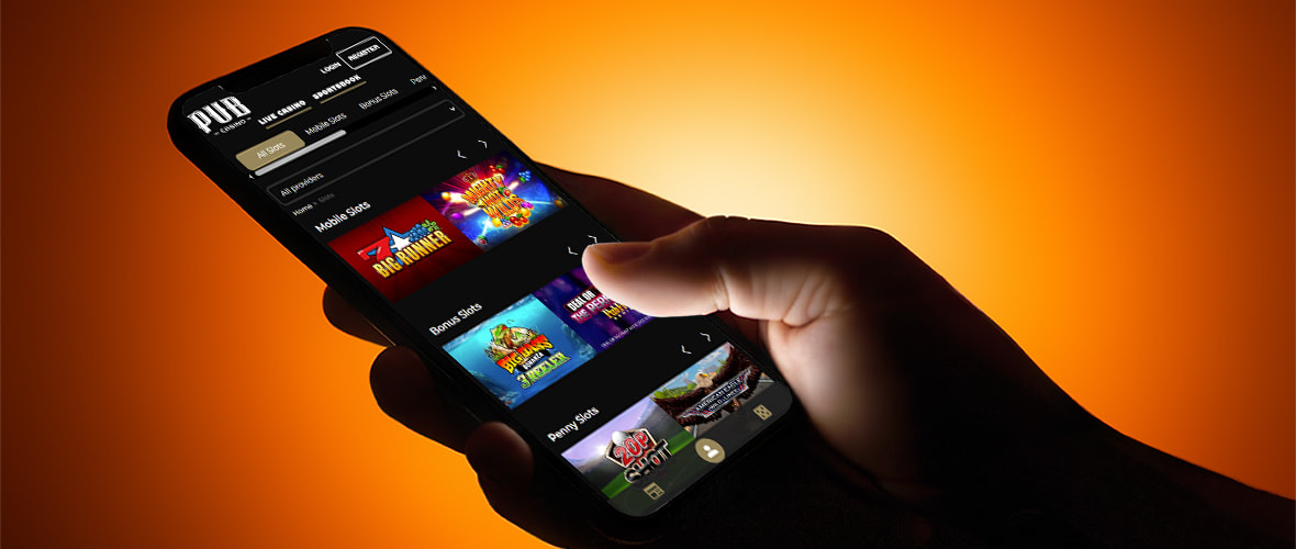 The Pub Casino lobby viewed on iPhone 15 - note the search bar placement and the provider filter.